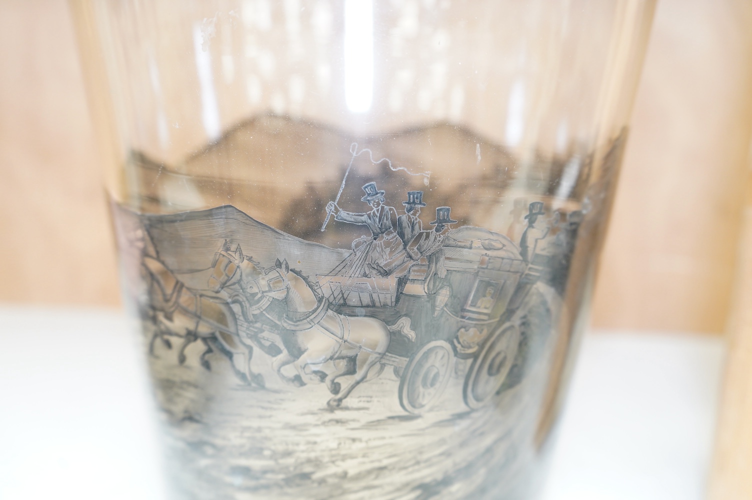 A large German Schwarzlot glass beaker vase, decorated with a painted agricultural scene, 27.5cm high. Condition - fair to good, one chip to the rim and scratches to the base